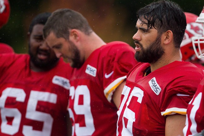 Kansas City Chiefs guard Laurent Duvernay-Tardif, right, looks on during the NFL football training camp, Sunday, Aug. 7, 2016, in St. Joseph, Mo.