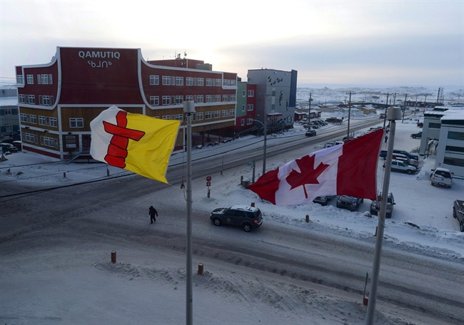 A Canadian flag and the Nunavut flag fly in Iqaluit, Nunavut on Thursday, Feb. 9, 2017.