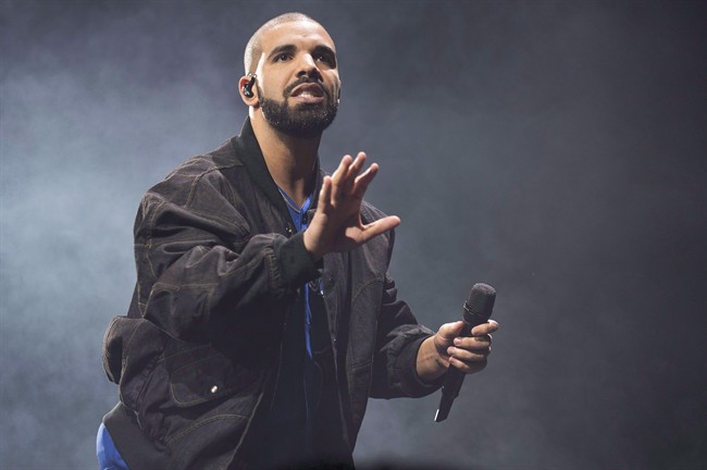 Drake performs onstage in Toronto in an Oct. 8, 2016 file photo. Several Canadians will be going for gold at tonight's Grammy Awards, including two of the country's biggest pop performers. Drake and Justin Bieber will square off against country singer Sturgill Simpson and pop powerhouses Adele and Beyonce, who are all nominated for album of the year.