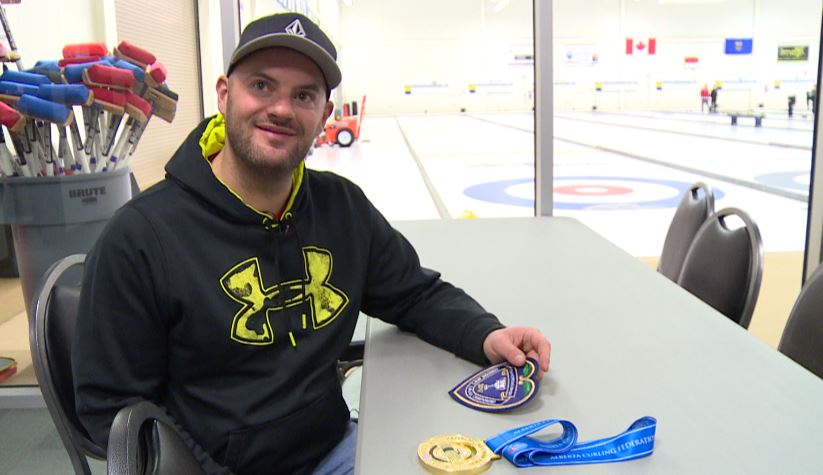Darren Moulding by his Purple Heart and gold medal from the Boston Pizza Alberta Cup.