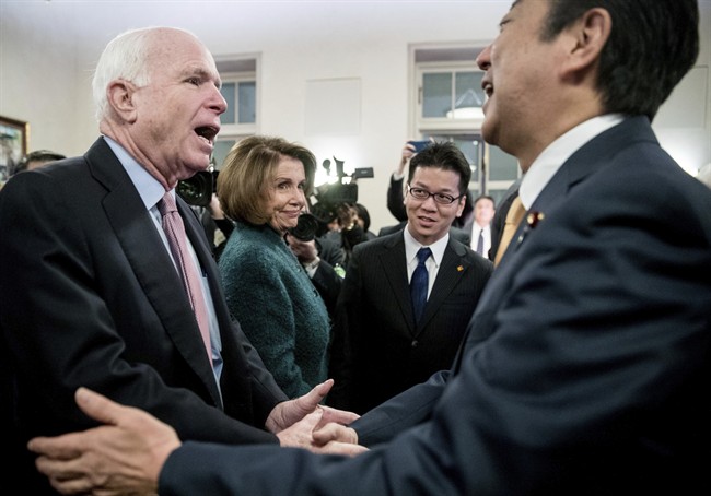 Japanese Prime Minister Shinzo Abe, right, greets House Minority Leader Nancy Pelosi of Calif., second from left, and Sen. John McCain, R-Ariz., left, at the U.S. Chamber of Commerce in Washington, Friday, Feb. 10, 2017. (AP Photo/Andrew Harnik).