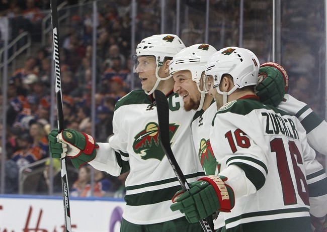 Minnesota Wild centre Mikko Koivu (9), right wing Chris Stewart (7) and left wing Jason Zucker (16) celebrate a goal against the Edmonton Oilers during third period NHL action in Edmonton, Alta., on Tuesday January 31, 2017. 