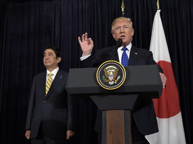 President Donald Trump speaks as Japanese Prime Minister Shinzo Abe listens as they both made statements about North Korea at Mar-a-Lago in Palm Beach, Fla., Saturday, Feb. 11, 2017.