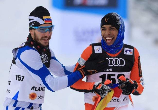 Solano is congratulated by compatriot Bernardo Baena after crossing the finish line.