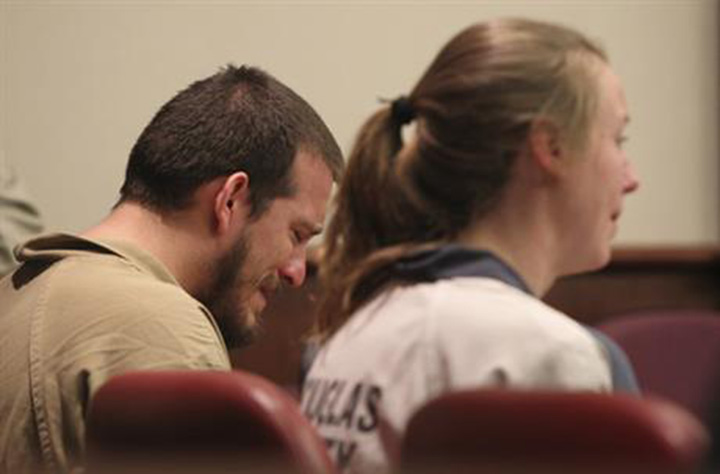 Jose Torres, left, weeps in his seat while during his sentencing at the Douglas County Courthouse in Douglasville, Ga., Monday, Feb. 27, 2017. Superior Court Judge William McClain sentenced Torres and Kayla Rae Norton, right, to lengthy prison terms Monday for their role in the disruption of a black child's birthday party with Confederate flags, racial slurs and armed threats. 