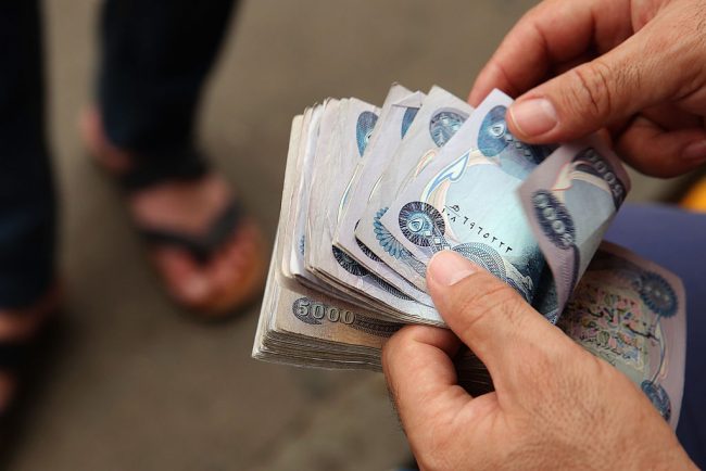 Currency is exchanged in the Qaysari Market in Erbil, Iraq, June 15, 2014.