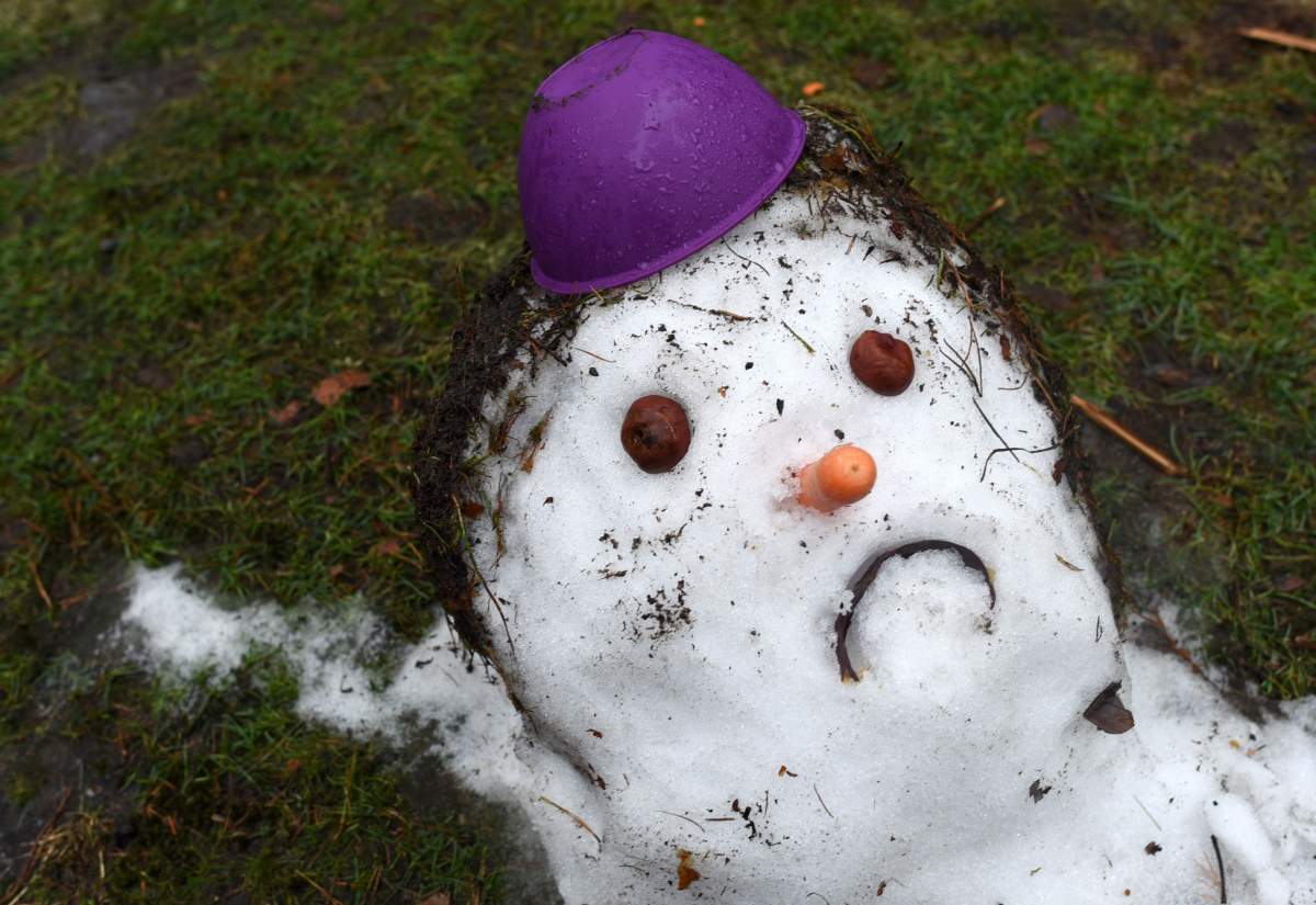 A snowman melts as the temperature rises.