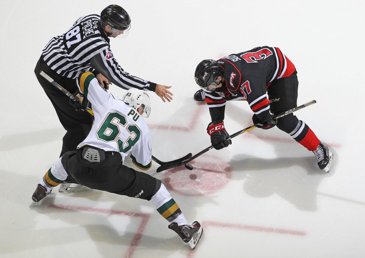 Nick Suzuki #37 of the Owen Sound Attack takes a faceoff against Cliff Pu #63 of the London Knights (Photo by Claus Andersen/Getty Images).