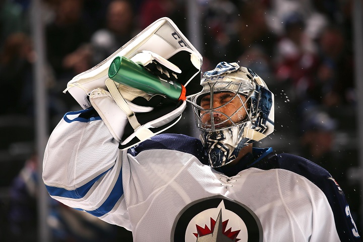 Winnipeg Jets goalie Ondrej Pavelec sprays water through his mask during a break in the action against the Colorado Avalanche on Feb. 4, 2017.