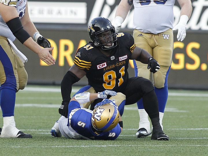 Drake Nevis sacks former Winnipeg Blue Bombers quarterback Drew Willy during a CFL game in Hamilton, ON. on July 7, 2016.