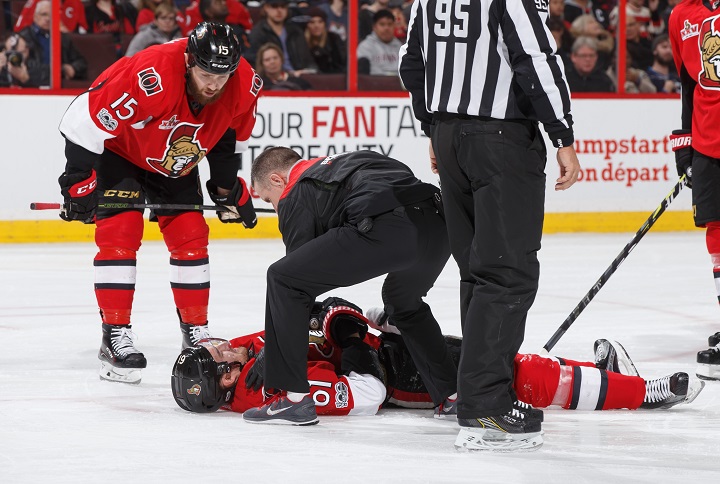 Mark Stone of the Ottawa Senators is examined after a hit to the head by Winnipeg Jets' Jacob Trouba in Sunday's game.