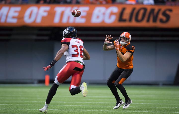 B.C. Lions' Nick Moore, right, makes a reception as Calgary Stampeders' Glenn Love defends during the first half of a pre-season CFL football game in Vancouver, B.C., on Friday June 17, 2016.