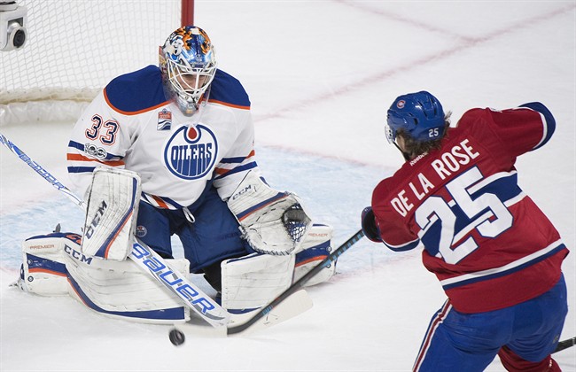 In this file photo, Montreal Canadiens' Jacob De la Rose takes a shot on Edmonton Oilers goaltender Cam Talbot. The team has placed De la Rose on waivers. Tuesday, Oct. 16, 2018. 