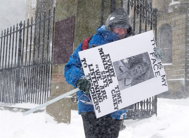 Rachel Creasor, a teacher at Glooscap Elementary School in Canning, N.S., protests outside the legislature in Halifax as a major winter storm blasts the Maritimes on Monday, Feb. 13, 2017. Premier Stephen McNeil's government is expected to introduce a bill on Tuesday that will impose a contract on the province's teachers.