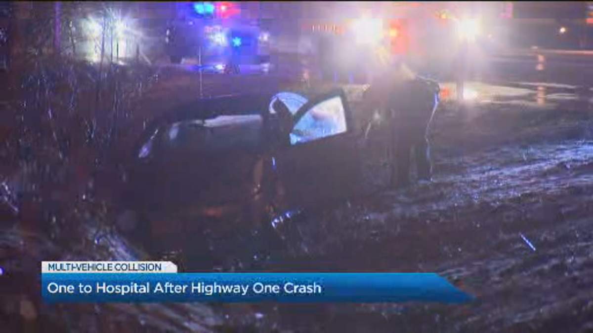 A Surrey RCMP officer goes to inspect one of the cars involved in the crash on Tuesday night.