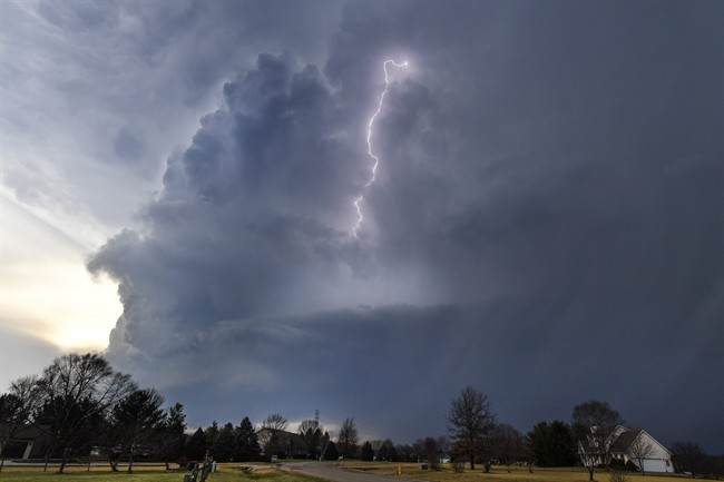 Lightning flashes in storm clouds over the village of Dunlap, Ill., Tuesday, Feb. 28, 2017. A spring-like storm churning across the Midwest poses a risk of more bad weather for millions of people. (Ron Johnson/Journal Star via AP).