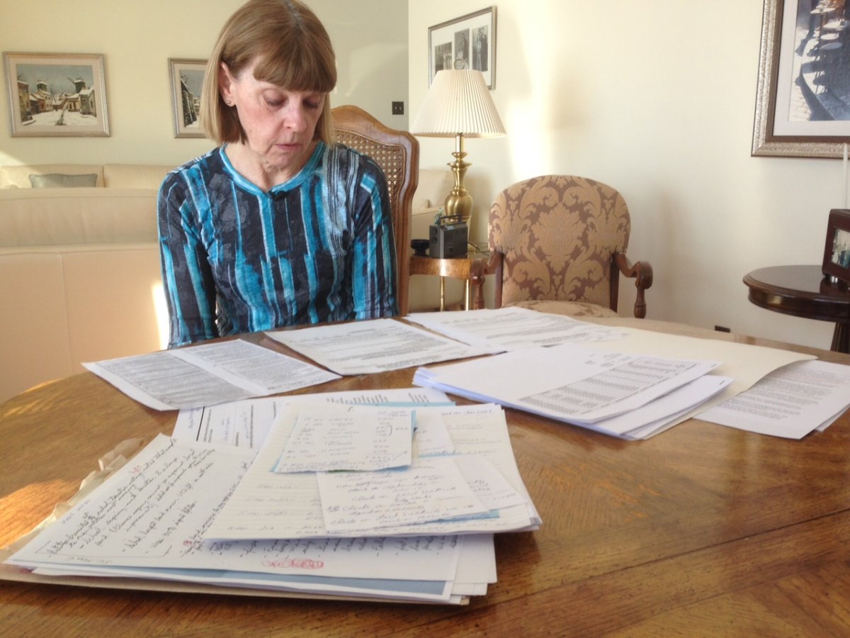 Cherry Karpyshin looks over the proposed fees she received that added up to $76,000.
