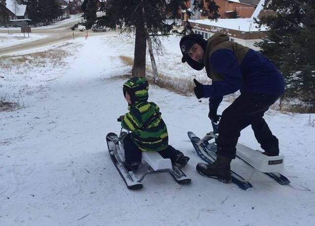 Lifelong resident Bas Byrd, 28, and his son Atreyu Byrd, 5, at popular “Church Hill” tobogganing spot in Jasper, Alta.
