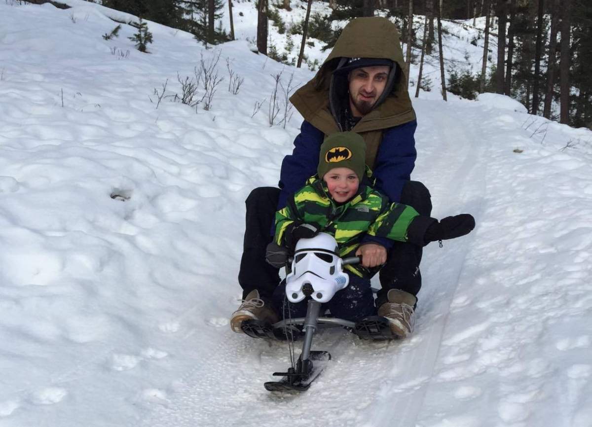 Lifelong resident Bas Byrd, 28, and his son Atreyu Byrd, 5, at popular “Church Hill” tobogganing spot in Jasper, Alta.