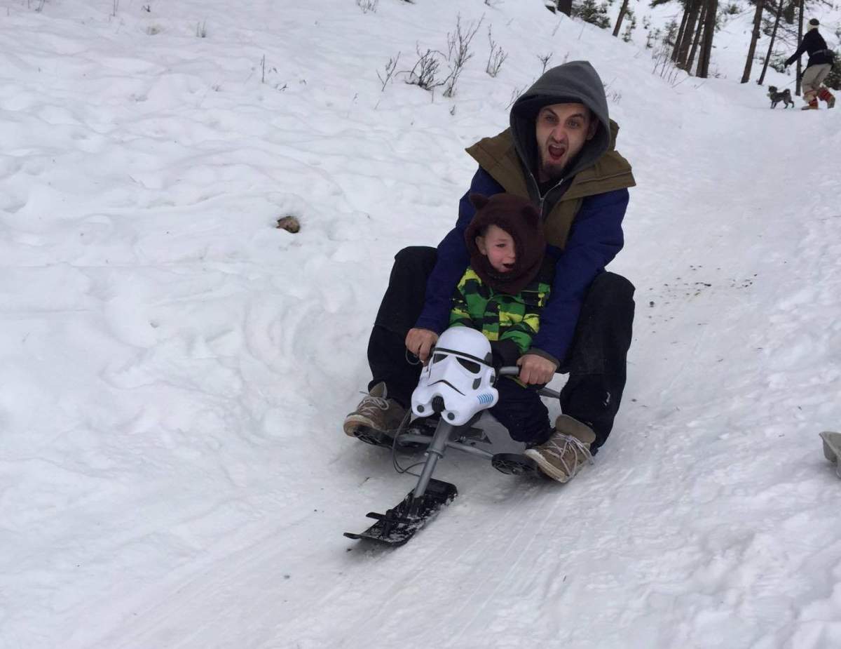 Lifelong resident Bas Byrd, 28, and his son Atreyu Byrd, 5, at popular “Church Hill” tobogganing spot in Jasper, Alta.