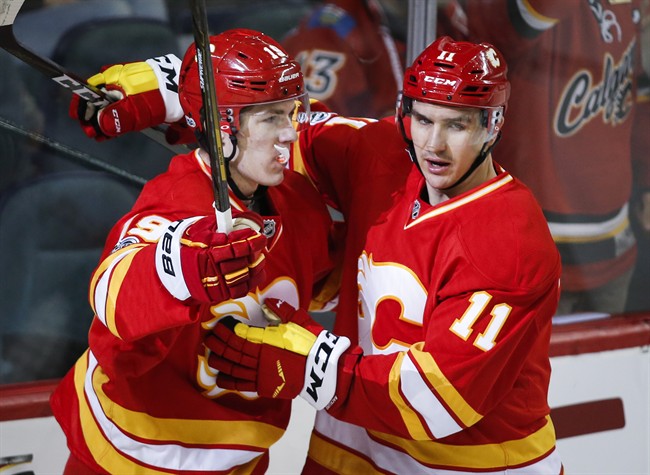 Calgary Flames left wing Matthew Tkachuk (19) celebrates his goal with teammate centre Mikael Backlund (11), from Sweden, during first period NHL hockey action against the Philadelphia Flyers in Calgary, Wednesday, Feb. 15, 2017. 