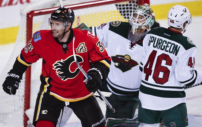 Minnesota Wild defenceman Jared Spurgeon (46) and goalie Devan Dubnyk (40) look away as Calgary Flames right wing Troy Brouwer (36) celebrates a goal during third period NHL hockey action in Calgary, Wednesday, Feb. 1, 2017. 