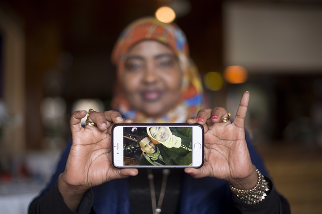 Saciido Shaie, founder and President of the Umma Project holds a picture of herself and close friend Mohamed Badal at a Somali restaurant in Minneapolis, Minn., on Thursday, Feb. 16, 2017.