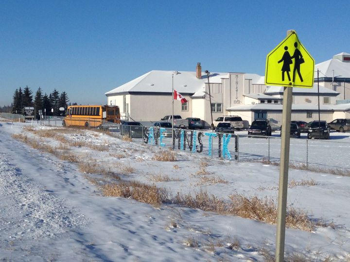 Parents put up a "Save Ministik" sign at Ministik School in rural Strathcona County. Feb. 7, 2017.