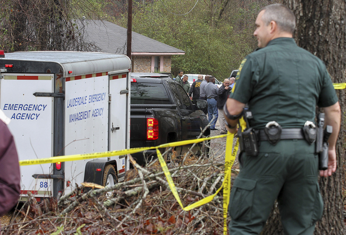 Lauderdale County authorities investigate the shooting deaths of four members of a family in Toomsuba, Miss., Tuesday, Feb. 21, 2017.