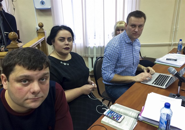 In this handout photo provided by Alexei Navalny press service Russian opposition leader Alexei Navalny, right, his former colleague Pyotr Ofitserov, left, and lawyer Svetlana Davydov, second left, sit in a courtroom in Kirov, Russia, Wednesday, Feb. 1, 2017.