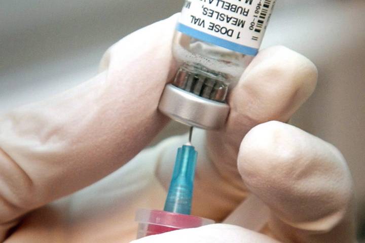 A nurse draws a dose of mumps, measles, and rubella vaccine in this file photo.