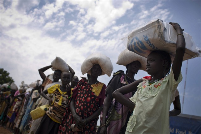 In this photo taken Wednesday, Oct. 19, 2016 and released by UNICEF, a young girl who fled fighting in nearby Leer in recent months, queues for food aid at a food distribution made by the World Food Programme in Bentiu, South Sudan. Famine has been declared Monday, Feb. 20, 2017 in two counties of South Sudan, according to an announcement by the South Sudan government and three U.N. agencies, which says the calamity is the result of prolonged civil war and an entrenched economic crisis that has devastated the war-torn East African nation. 