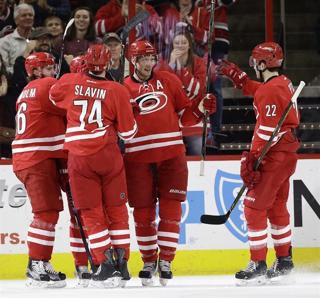 Carolina Hurricanes' Jordan Staal (11) is congratulated by Brett Pesce (22), Jaccob Slavin (74) and Elias Lindholm (16), of Sweden, following Staal's goal against the Edmonton Oilers during the first period of an NHL hockey game in Raleigh, N.C., Friday, Feb. 3, 2017. 