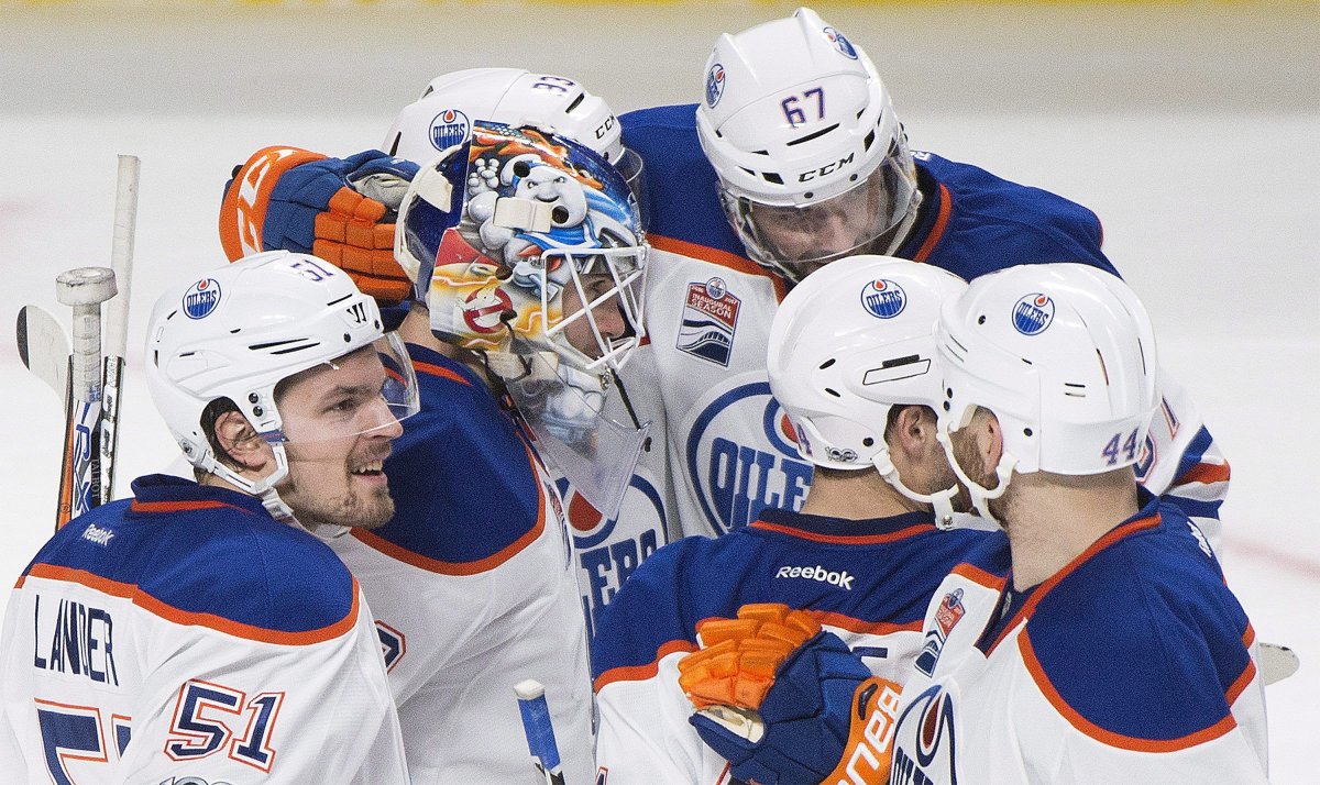Edmonton Oilers players celebrate with goaltender Cam Talbot after beating the Montreal Canadiens in an NHL hockey game in Montreal, Sunday, February 5, 2017. THE CANADIAN PRESS/Graham Hughes.