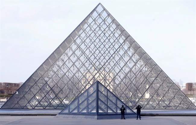 Police officers patrol at the pyramid outside the Louvre museum in Paris,Friday, Feb. 3, 2017. Paris police say a soldier has opened fire outside the Louvre Museum after he was attacked by someone, and the area is being evacuated. (AP Photo/Thibault Camus).
