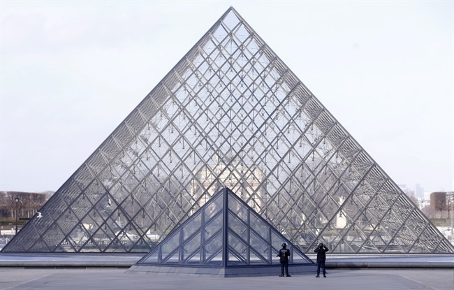 Police officers patrol at the pyramid outside the Louvre museum in Paris,Friday, Feb. 3, 2017. Paris police say a soldier has opened fire outside the Louvre Museum after he was attacked by someone, and the area is being evacuated. (AP Photo/Thibault Camus).