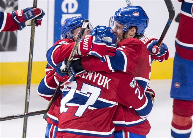 Montreal Canadiens' Shea Weber, right, and Brendan Gallagher, left, hug teammate Alex Galchenyuk.