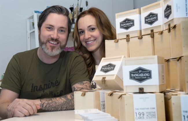 Martin Brouillard and Marie-Eve D'Amico are seen next to a display of Positive Cubes, a small wooden box produced by the Quebec-based company Bangarang Friday, February 24, 2017 in Beloeil, Que. The boxes that contain 199 cards, each bearing a positive or inspirational saying, will be part of the gift bags handed out at the Oscars Sunday.