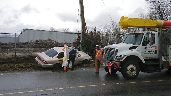Crews attend to the car that was hijacked by a suspect in Port Coquitlam on Feb. 16, 2017.