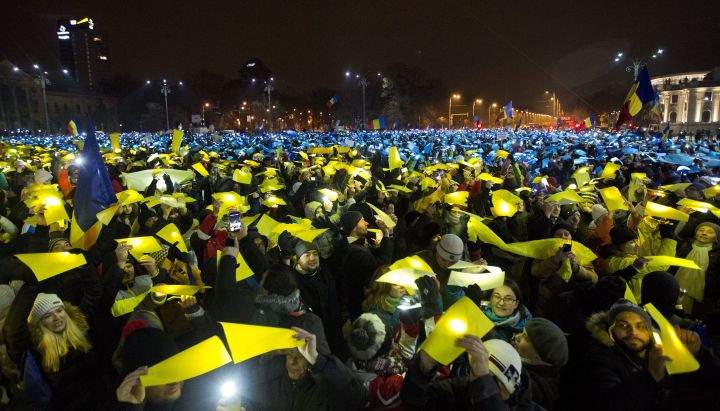 Protesters lit torches using national colours during a demonstration in Bucharest, Romania, Sunday, Feb. 12, 2017. Romania has seen massive protests this month against a government decree that would have diluted the anti-corruption fight that has targeted top officials.
