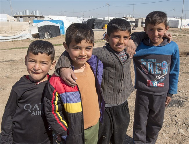 A group of Yazidi boys pose for a photo at a camp for internal displaced persons, Wednesday, February 22, 2017 in Dohuk, Iraq. 