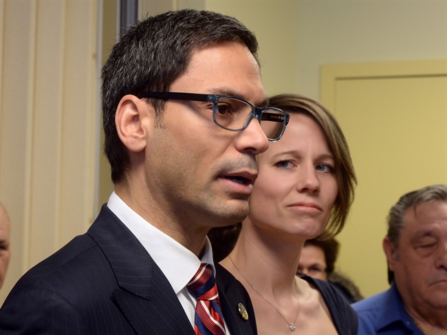 Former Quebec government House Leader Gerry Sklavounos speaks to media as wife Janneke looks on during a news conference, in Montreal on Thursday, February 9, 2017.