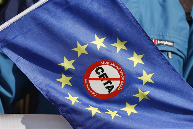 An anti-CETA sticker is pictured on an European flag during a demonstration against the so-called CETA trade deal outside the European Parliament in Strasbourg, eastern France, Wednesday, Feb.15, 2017.