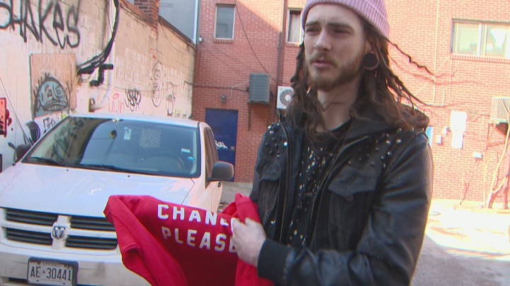 Homeless Toronto co-founder Trevor Nicholls shows off one of the shirts in the company's clothing line.