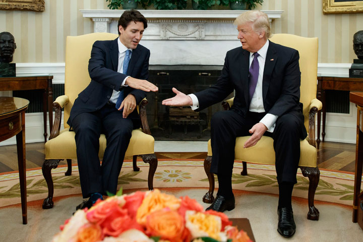 U.S. President Donald Trump reaches to shakes hands with  Prime Minister Justin Trudeau in the Oval Office of the White House in Washington, Monday, Feb. 13, 2017. 