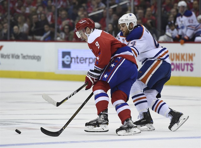 Edmonton Oilers right wing Zack Kassian (44) chases down Washington Capitals defenseman Dmitry Orlov (9), of Russia, for the puck during first period of an NHL hockey game, Friday, Feb. 24, 2017, in Washington. 