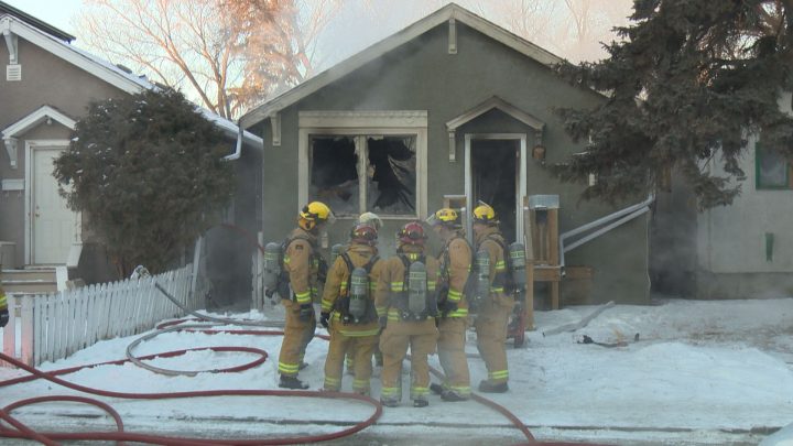 Regina firefighters stand outside at the scene of a house fire on the 1400 block of Wascana Street on Feb. 2. 