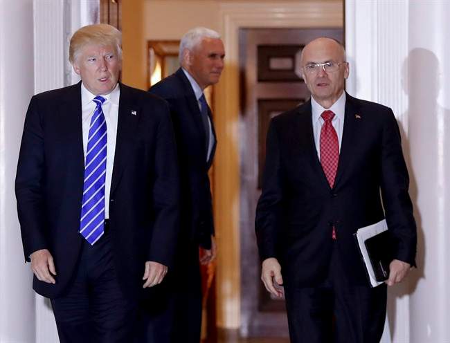 In this Nov. 19, 2016 file photo, President-elect Donald Trump walks Andy Puzder, who has withdrawn as Trump's nominee for labour secretary.