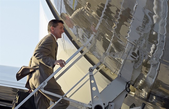 In this Feb. 12, 2017, photo, National Security Adviser Michael Flynn boards Air Force One at Palm Beach International Airport in West Palm Beach, Fla., as he returned to Washington with President Donald Trump.