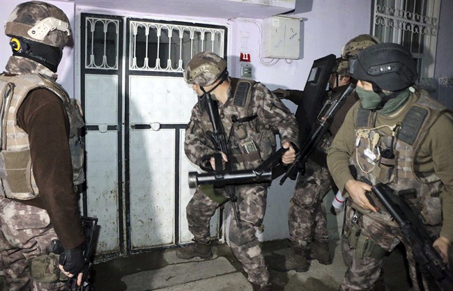 Turkish anti-terrorism police break a door during an operation to arrest people over alleged links to the Islamic State group, in Adiyaman, southeastern Turkey, early Sunday, Feb. 5, 2017. Police say they've arrested four ISIS members along with 150 kilos of explosives.